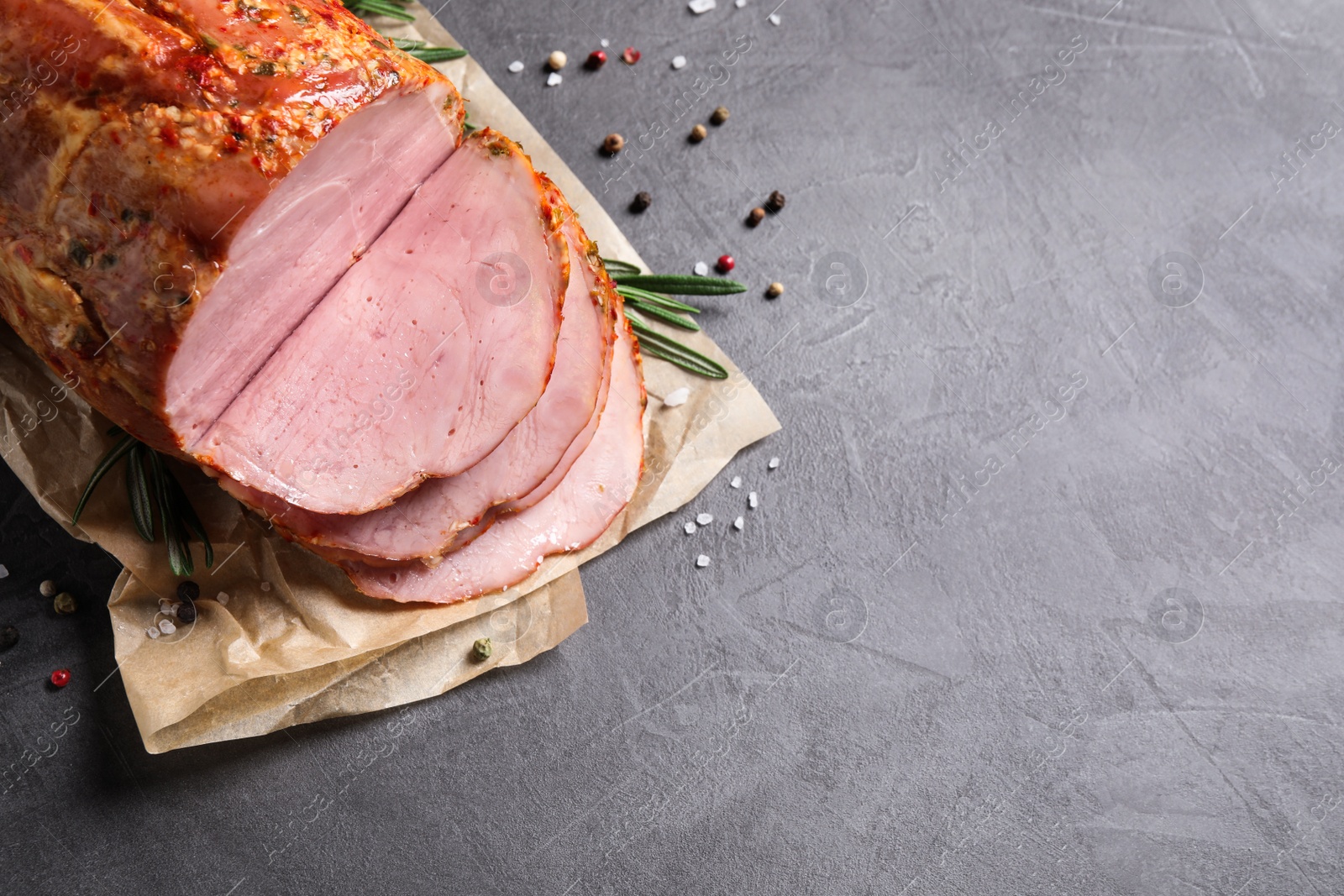 Photo of Delicious ham on grey table, top view with space for text. Christmas dinner