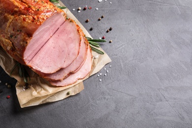 Delicious ham on grey table, top view with space for text. Christmas dinner