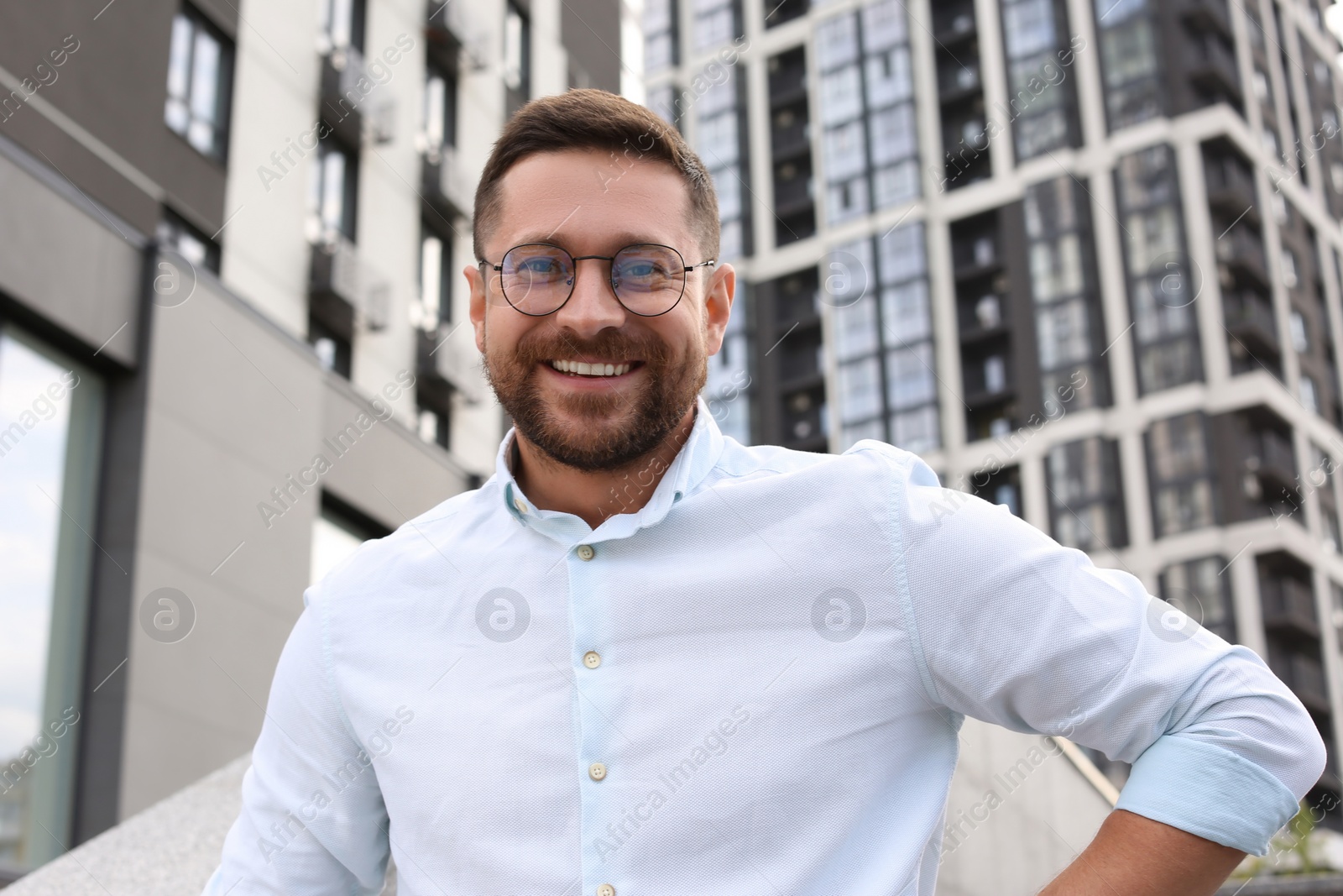 Photo of Portrait of handsome bearded man in glasses outdoors