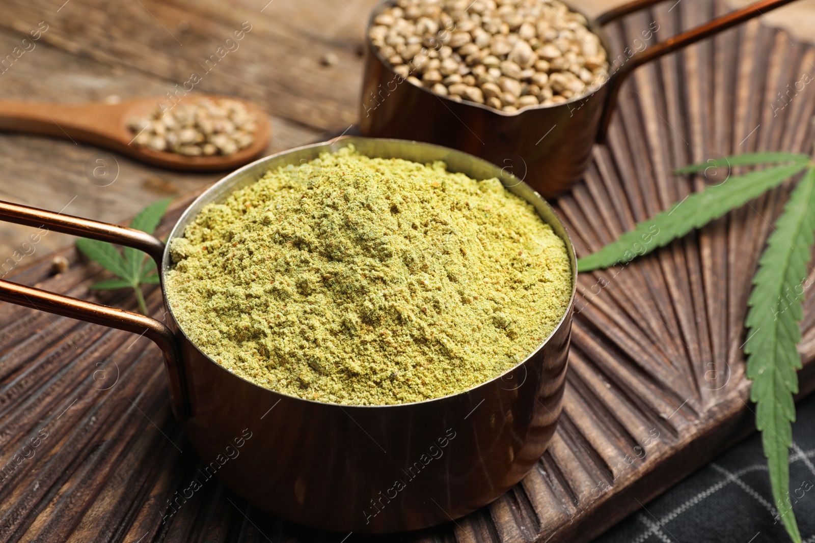 Photo of Composition with hemp protein powder and seeds on wooden board, closeup