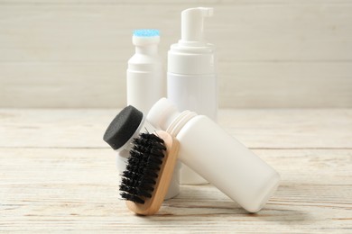 Photo of Composition with shoe care accessories on white wooden table, closeup