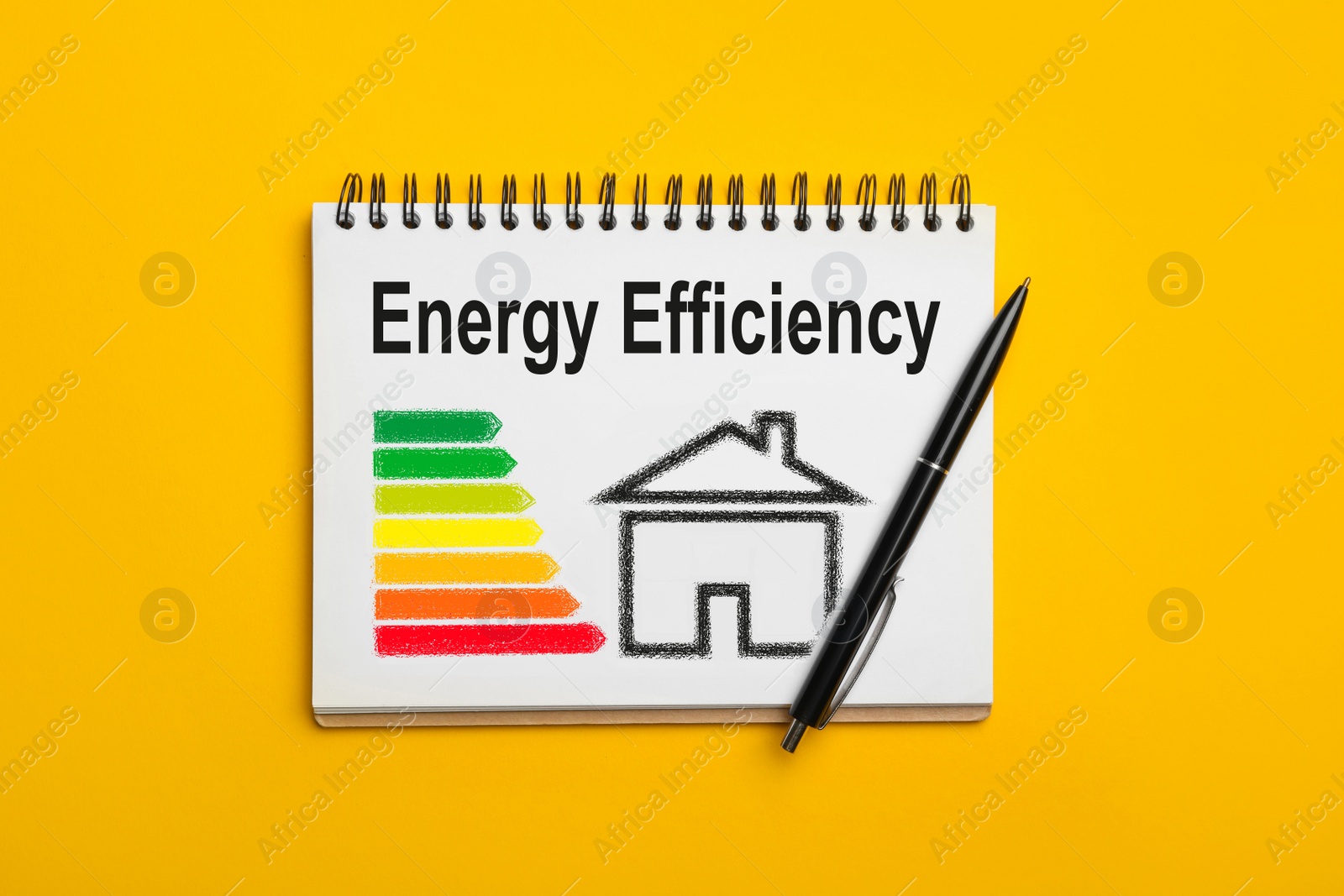 Image of Energy efficiency concept. Notebook with drawn house and chart on yellow background, top view
