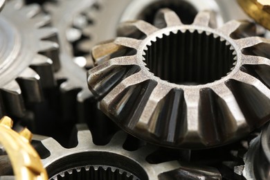 Many different stainless steel gears as background, closeup