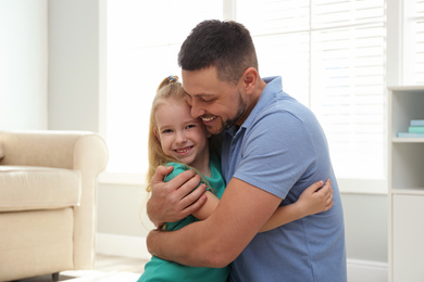 Photo of Dad and daughter spending time together at home. Happy Father's Day