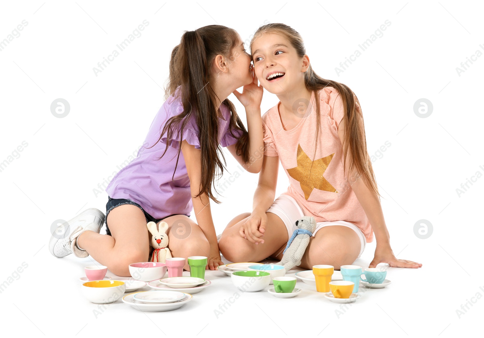 Photo of Little children playing tea party with toys on white background. Indoor entertainment