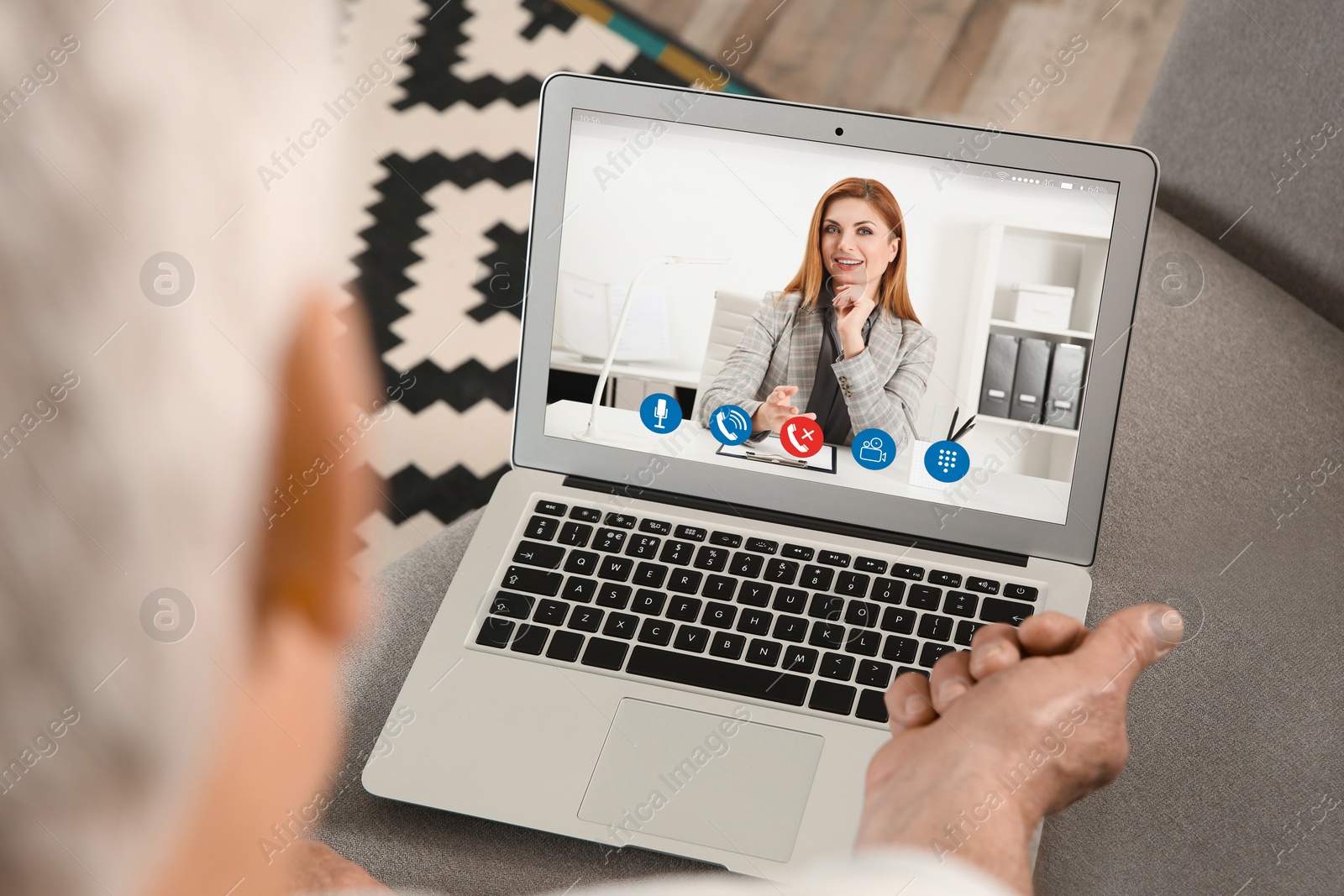 Image of Man using laptop at home for online consultation with psychologist via video chat, focus on screen