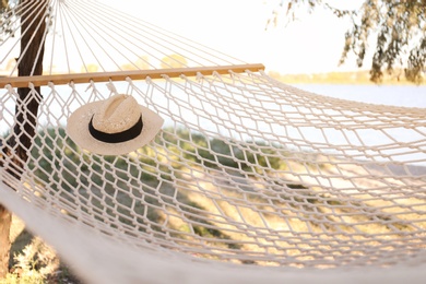 Hat in comfortable hammock on beach. Summer vacation