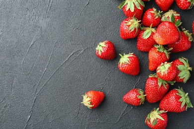 Ripe red strawberries on black background, top view