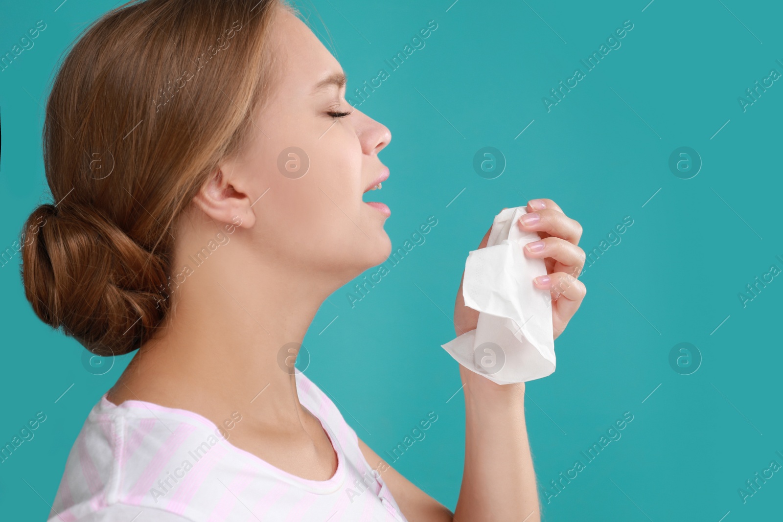 Photo of Young woman suffering from allergy on turquoise background