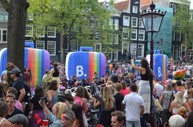 Photo of AMSTERDAM, NETHERLANDS - AUGUST 06, 2022: Many people at LGBT pride parade on summer day