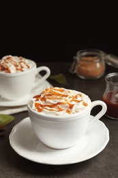 Cup of coffee with caramel topping on table