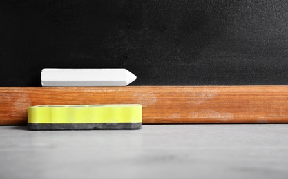 Photo of Chalk and duster on table in classroom