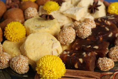 Diwali celebration. Tasty Indian sweets and spices on plate, closeup