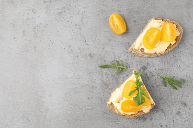 Tasty fresh tomato bruschettas on grey table, flat lay. Space for text