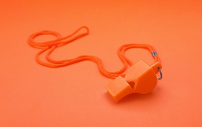 One color whistle with cord on orange background
