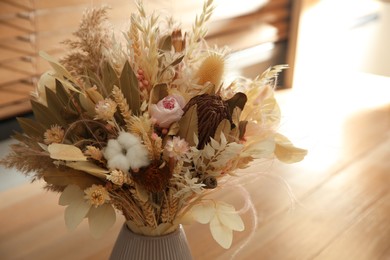 Bouquet of dry flowers on table indoors