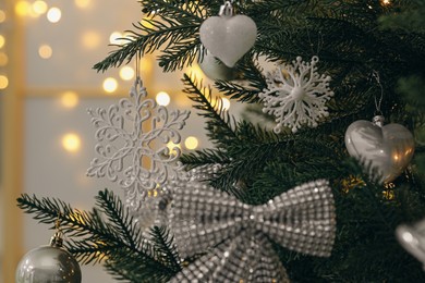 Photo of Closeup of different beautiful baubles hanging on Christmas tree