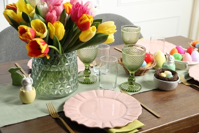 Easter celebration. Festive table setting with beautiful flowers and painted eggs