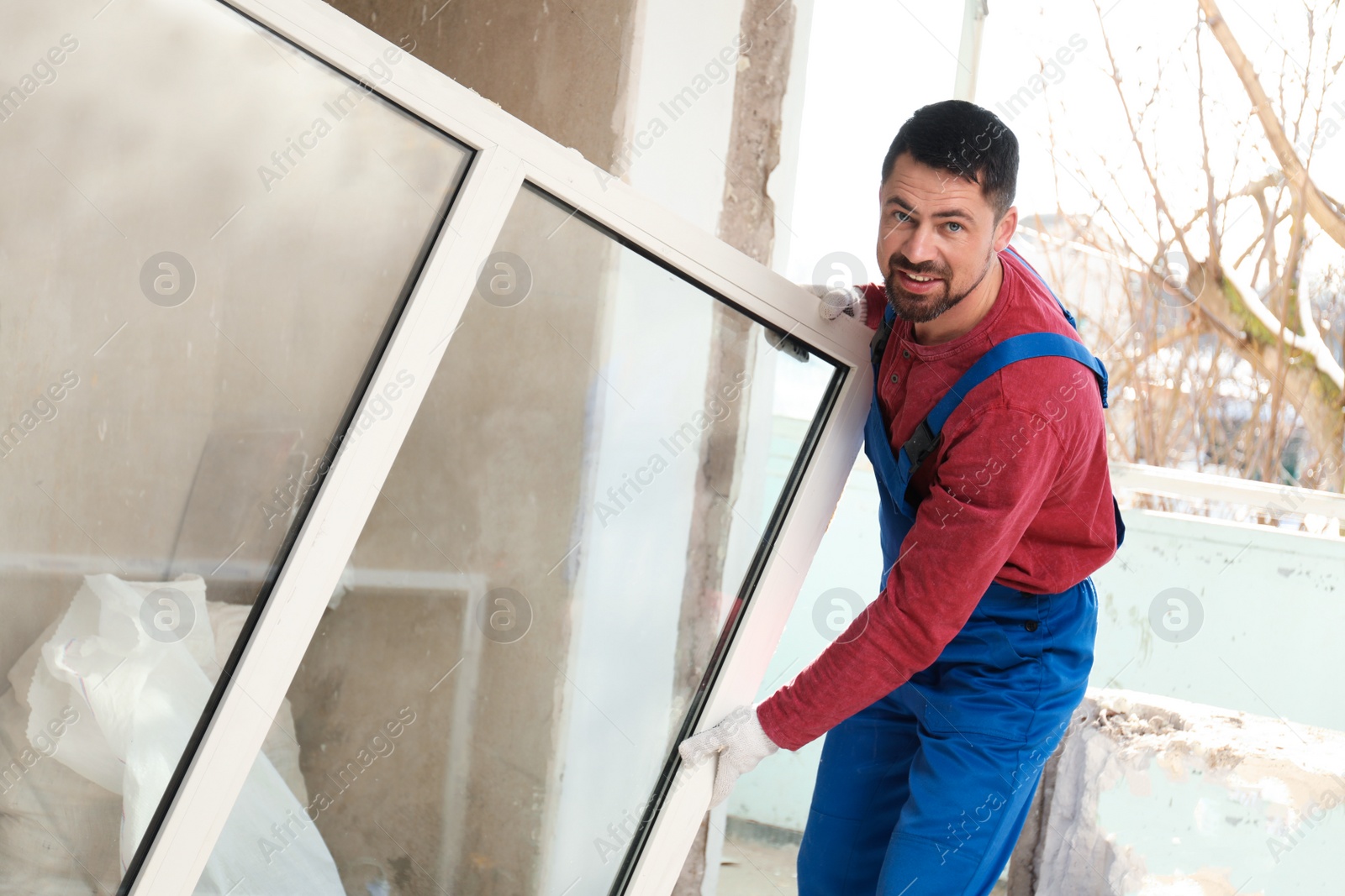 Photo of Worker in uniform with plastic window indoors