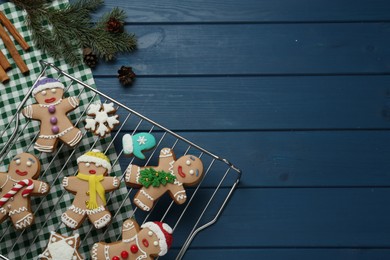 Photo of Flat lay composition with delicious Christmas cookies on blue wooden table, space for text