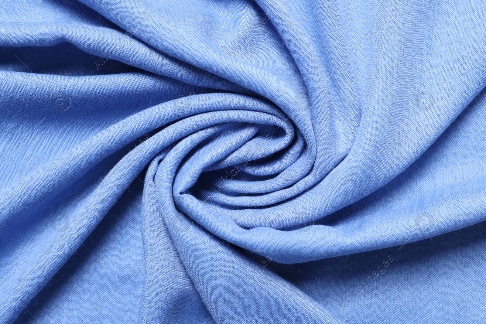 Photo of Texture of light blue crumpled fabric as background, top view