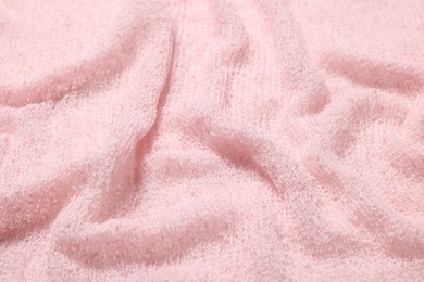 Texture of soft pink crumpled fabric as background, closeup