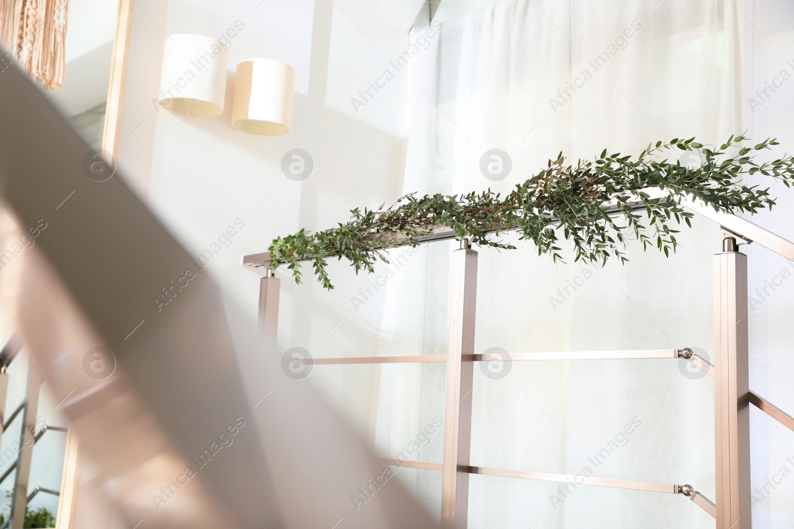 Photo of Stylish room decorated with beautiful eucalyptus garland