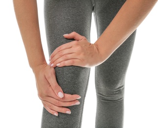Woman having knee problems on white background, closeup