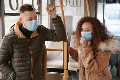 Photo of Couple with disposable masks on bus. Virus protection