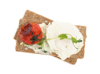 Photo of Fresh rye crispbreads with poached egg, cream cheese and grilled tomato on white background, top view