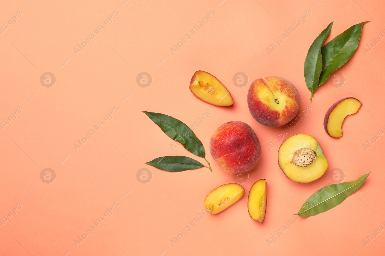 Photo of Flat lay composition with sweet juicy peaches and space for text on orange background