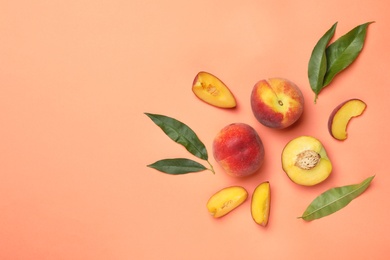 Photo of Flat lay composition with sweet juicy peaches and space for text on orange background