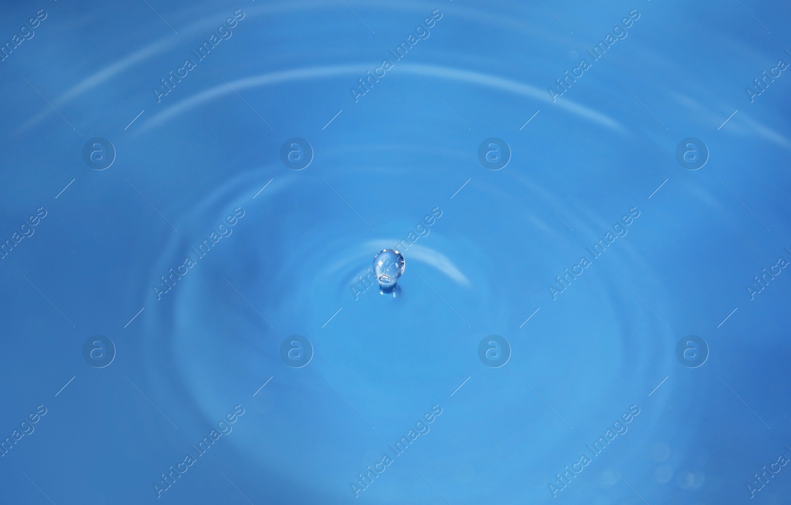 Photo of Splash of blue water as background, closeup