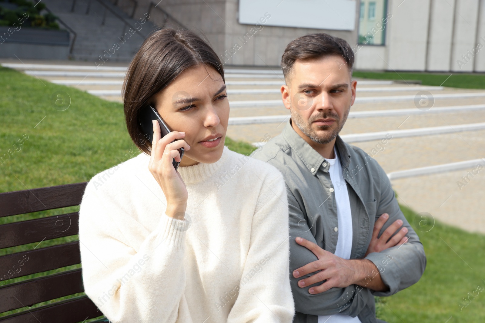 Photo of Woman ignoring her boyfriend and talking on phone. Relationship problems