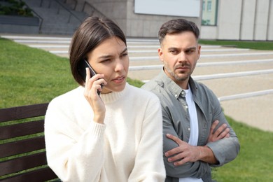 Woman ignoring her boyfriend and talking on phone. Relationship problems