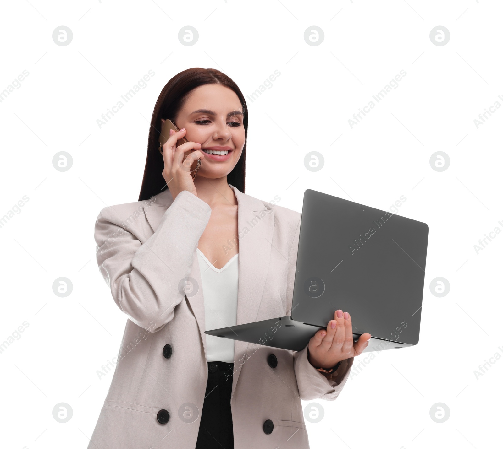 Photo of Beautiful businesswoman in suit with laptop talking on smartphone against white background, low angle view