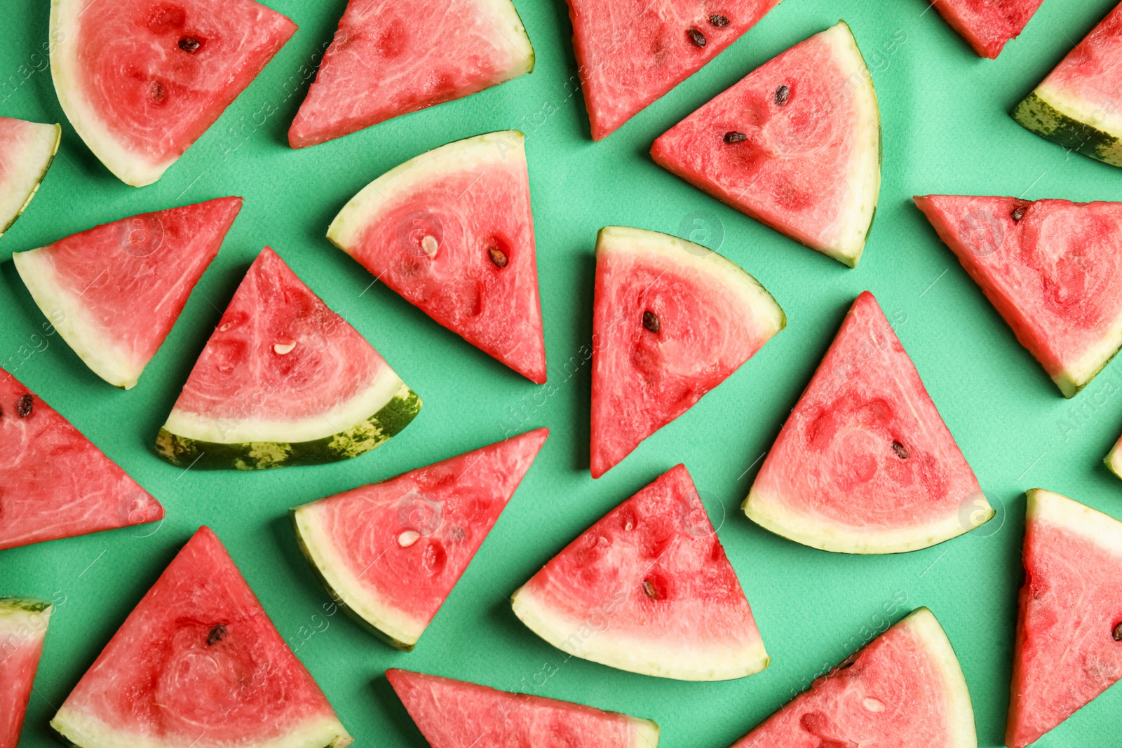 Photo of Slices of ripe watermelon on green background, flat lay