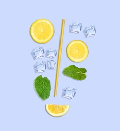 Image of Creative lemonade layout with lemon slices, mint, ice cubes and straw on light blue background, top view