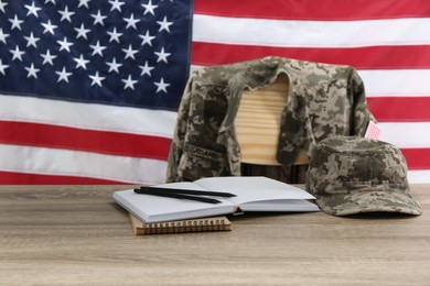 Stationery and soldier uniform near flag of United States. Military education