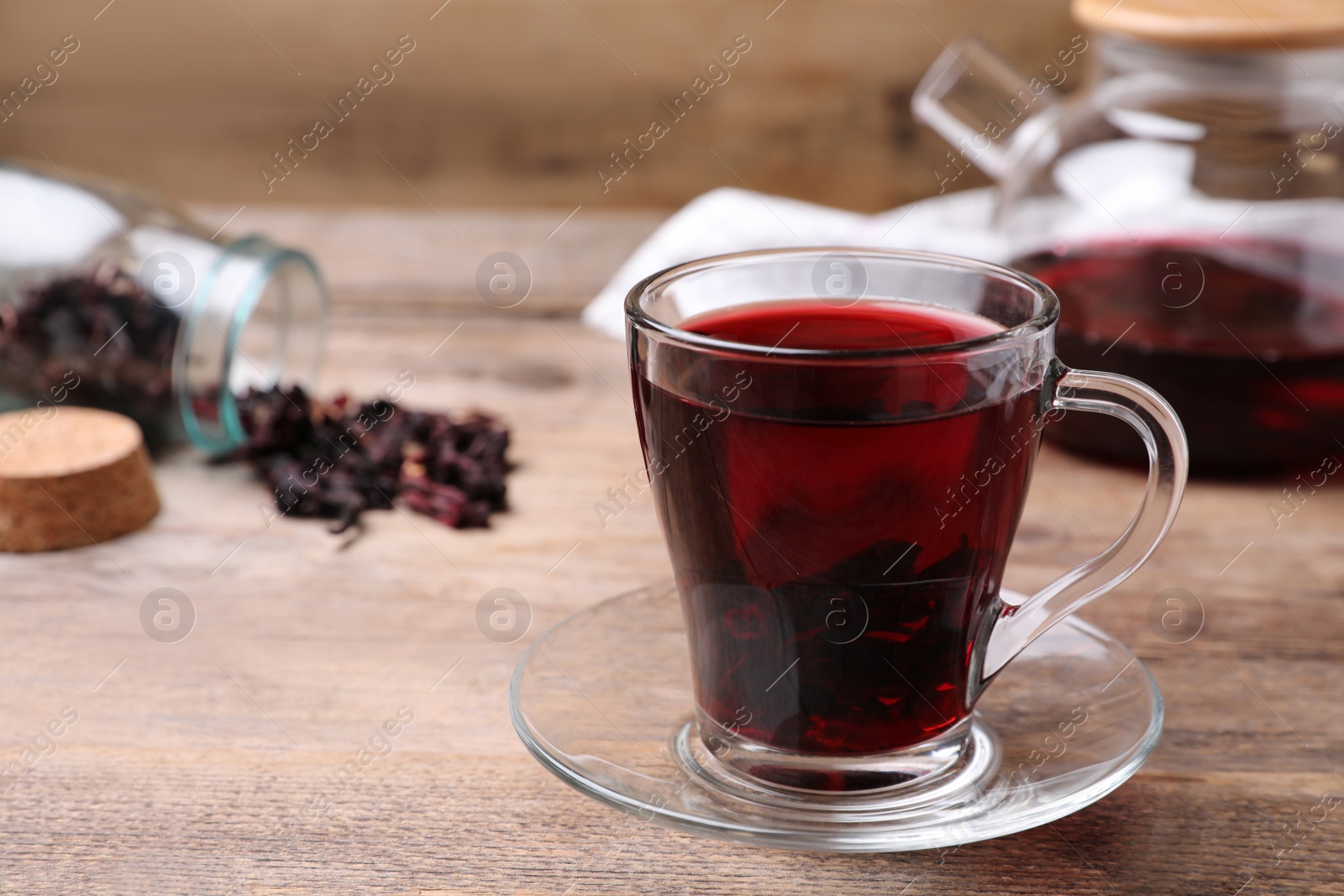 Photo of Freshly brewed hibiscus tea on wooden table