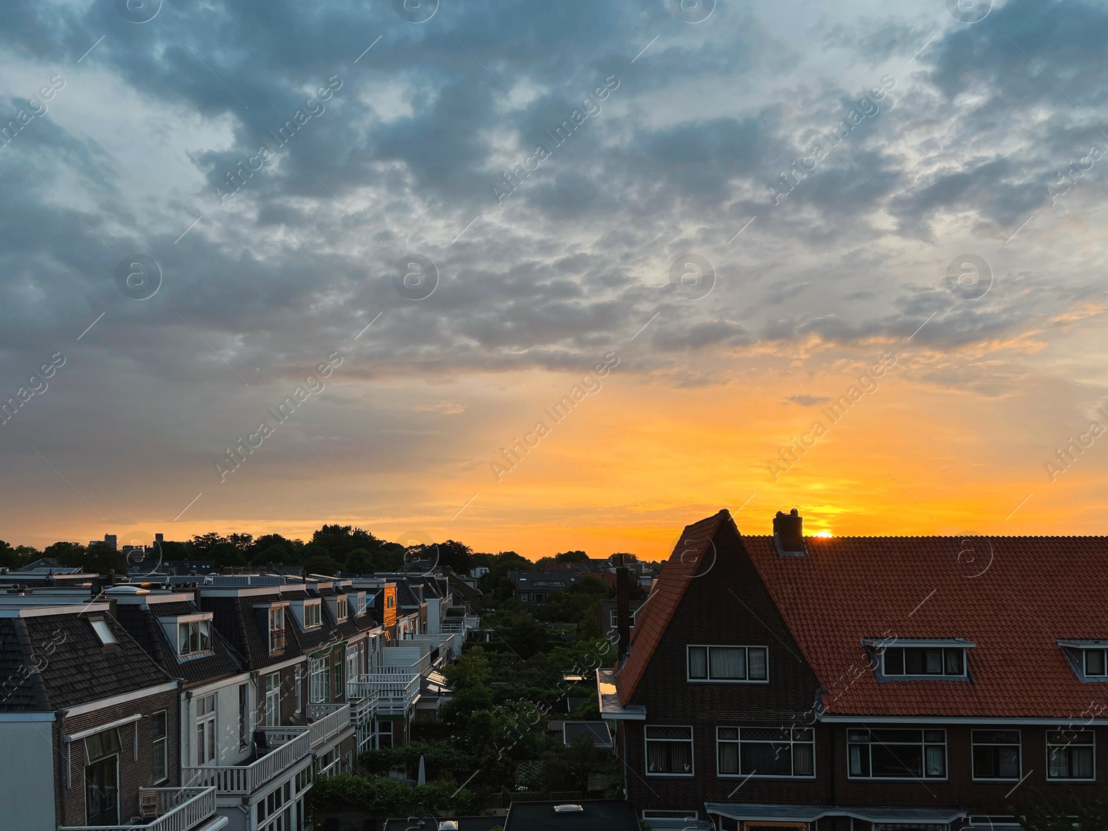 Photo of Picturesque view of city street with beautiful buildings at sunrise