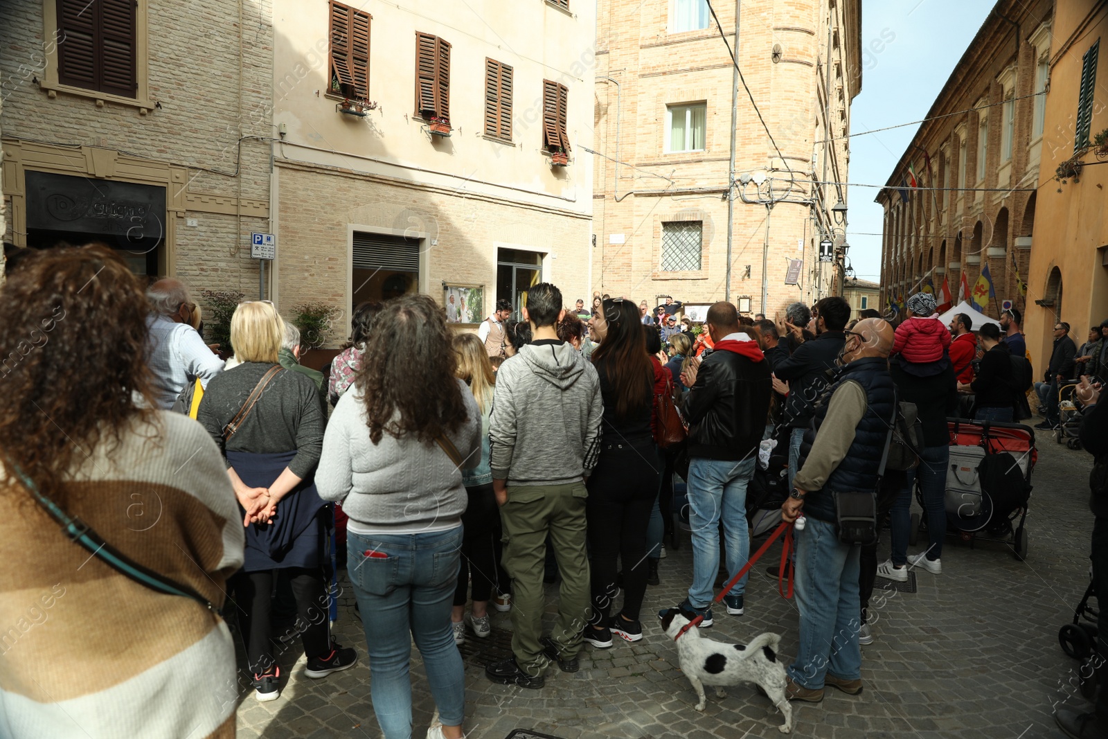 Photo of Narrow city street with crowd of people