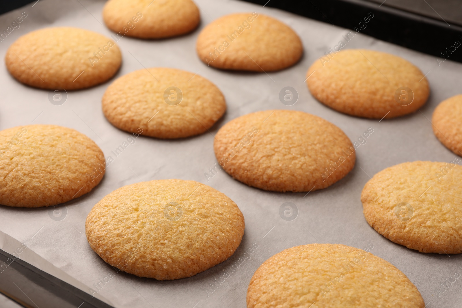 Photo of Delicious Danish butter cookies on baking tray, closeup