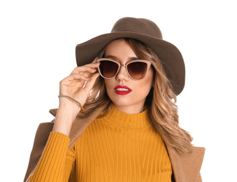 Young woman wearing stylish sunglasses and hat on white background