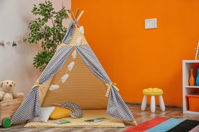 Cozy kids room interior with play tent and toys