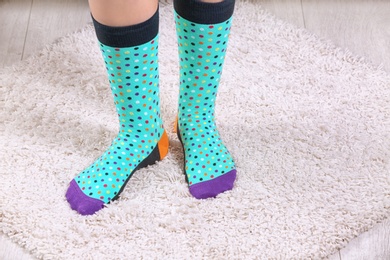 Woman in stylish socks on fuzzy carpet, closeup