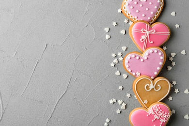 Photo of Flat lay composition with decorated heart shaped cookies and space for text on table