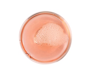 Photo of Glass of rose champagne isolated on white, top view