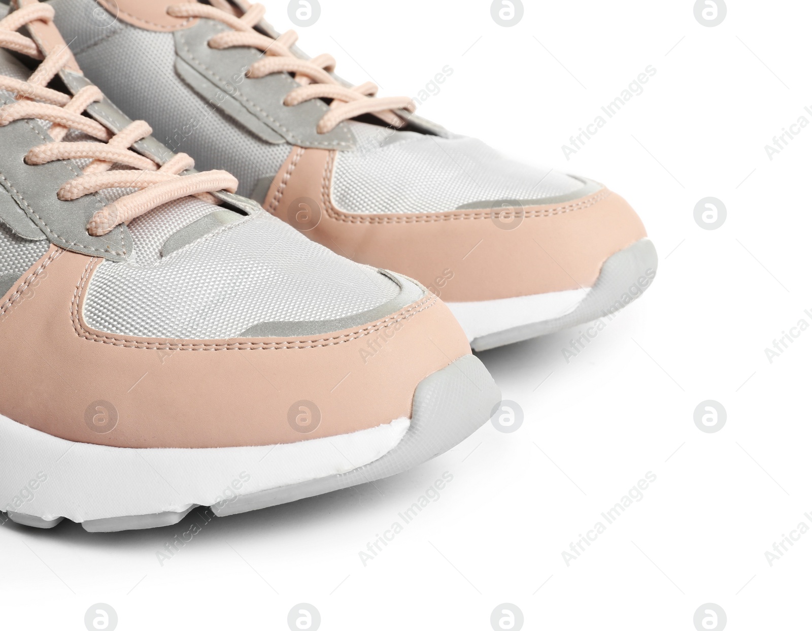 Photo of Pair of sports shoes on white background, closeup