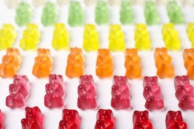 Photo of Many delicious little jelly bears on white background